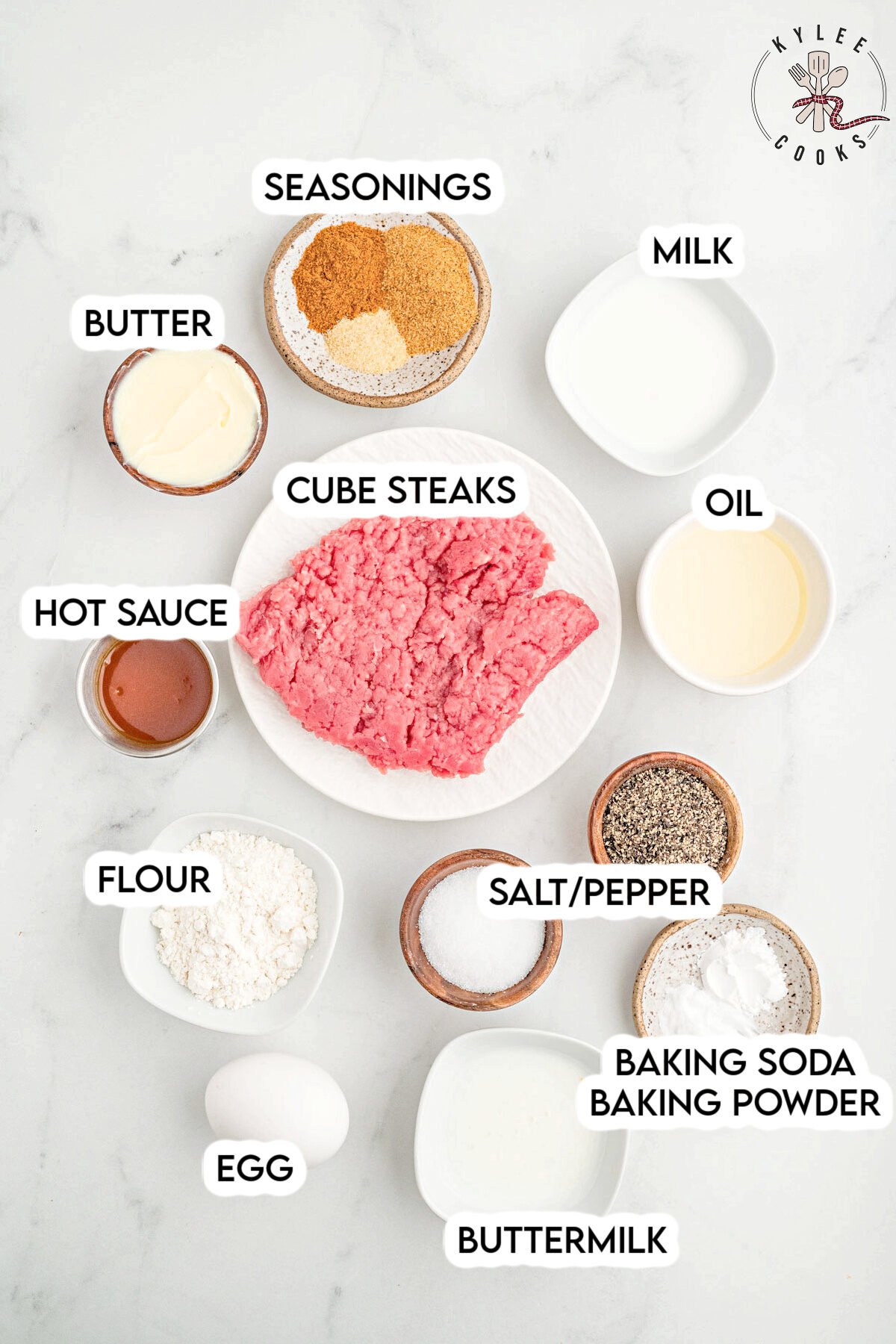 Labeled ingredients for chicken fried steak including cube steaks, seasonings, baking soda, baking powder, oil, butter, hot sauce, flour, salt, pepper, egg, and buttermilk.