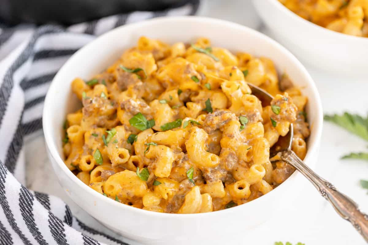 bowl of macaroni pasta with a striped napkin.