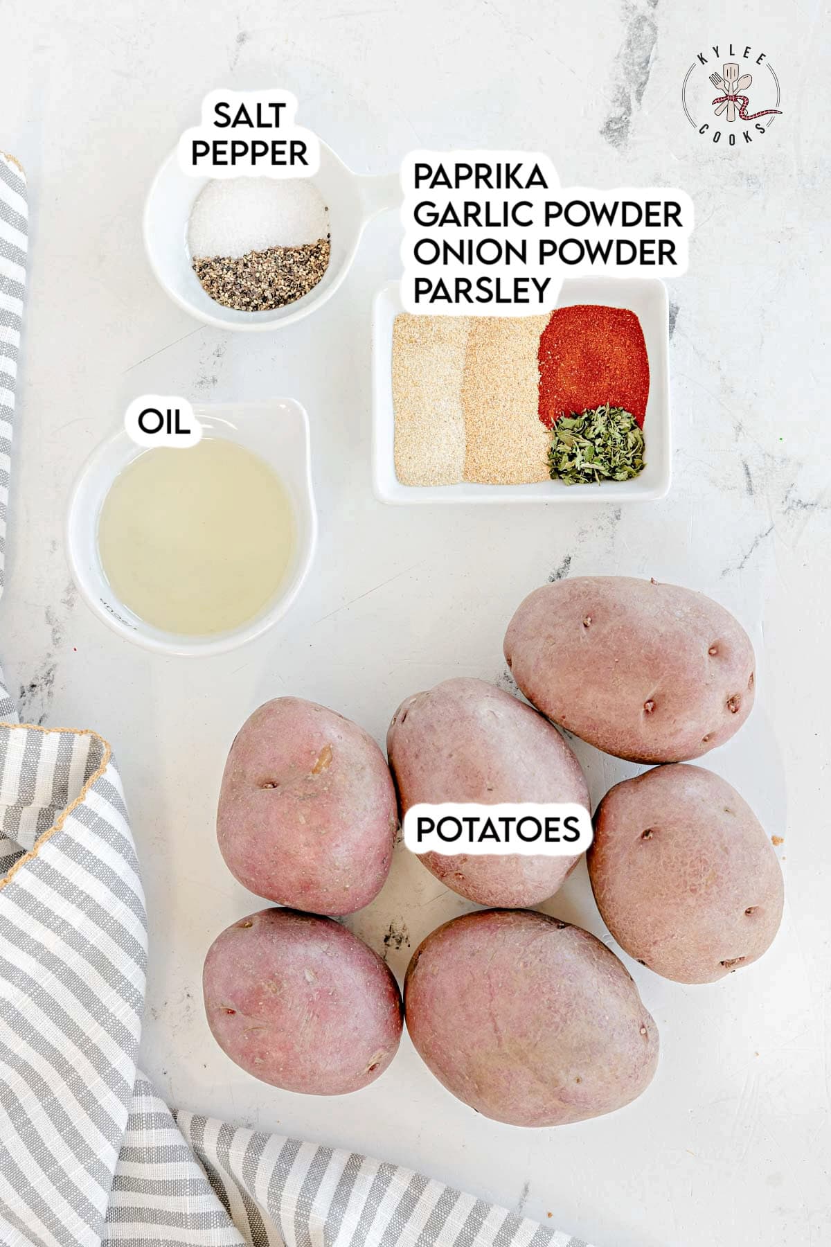 Whole red potatoes, oil, salt, pepper, and a dish with paprika, garlic powder, onion powder, and parsley. Text on the image says 'POTATOES', 'OIL', 'SALT PEPPER', and 'PAPRIKA GARLIC POWDER ONION POWDER PARSLEY'