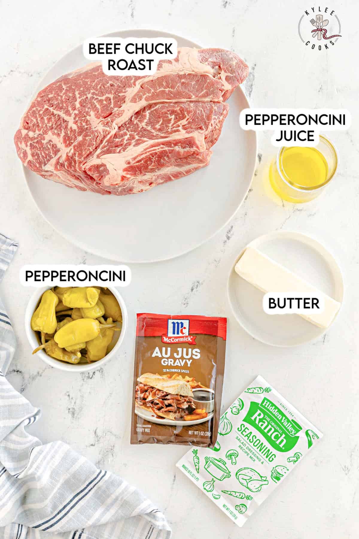 Ingredients for a mississippi pot roast recipe: beef chuck roast, pepperoncini, pepperoncini juice, butter, au jus gravy mix, ranch seasoning.