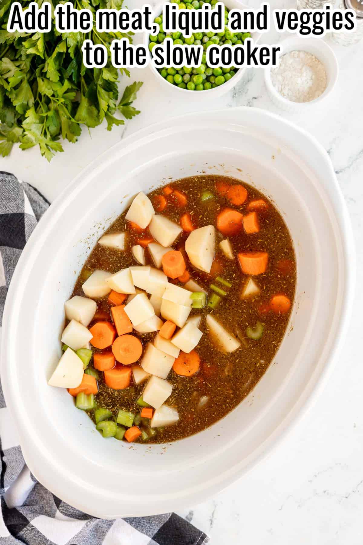 crockpot process shot of veggies and liquids added.