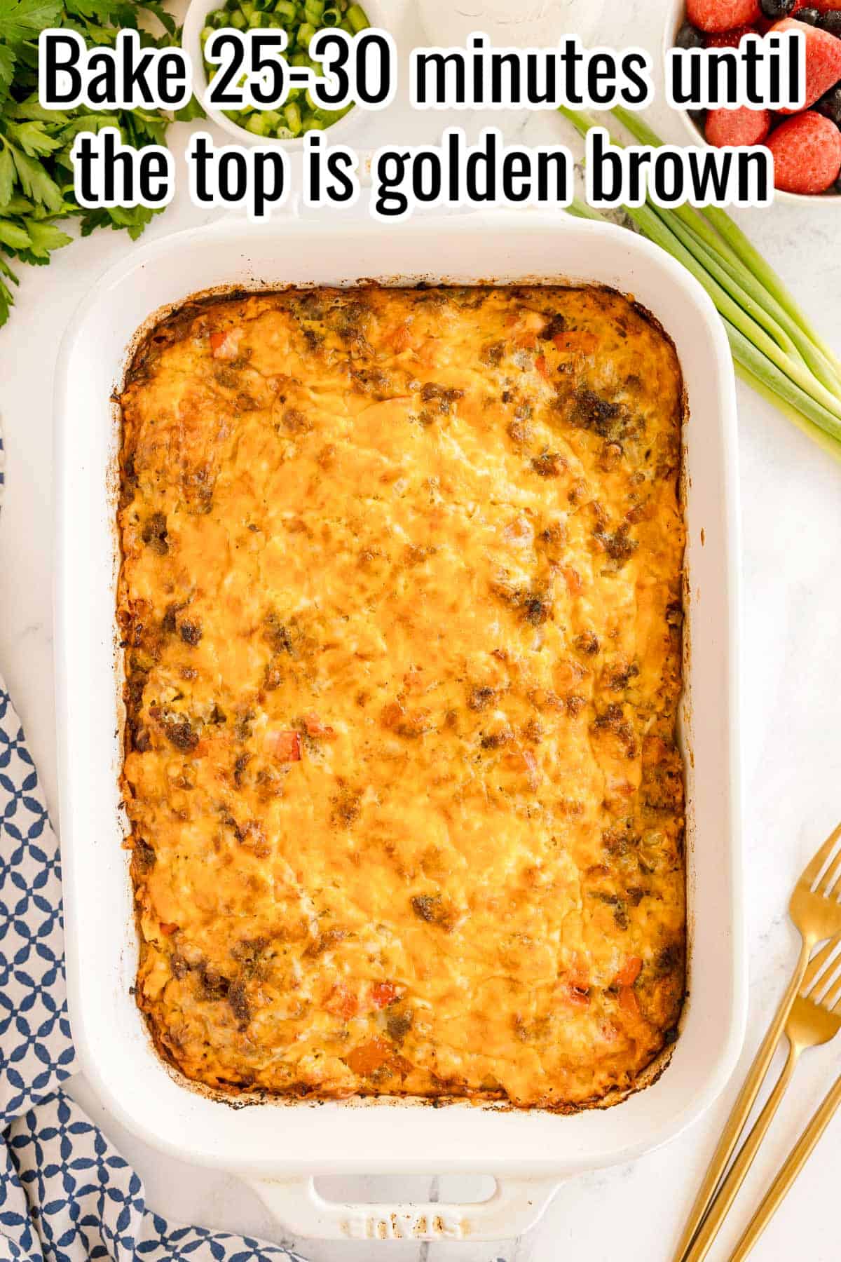 Fully baked casserole with a golden cheesy top. Text on the image says 'Bake 25–30 minutes until the top is golden brown'.