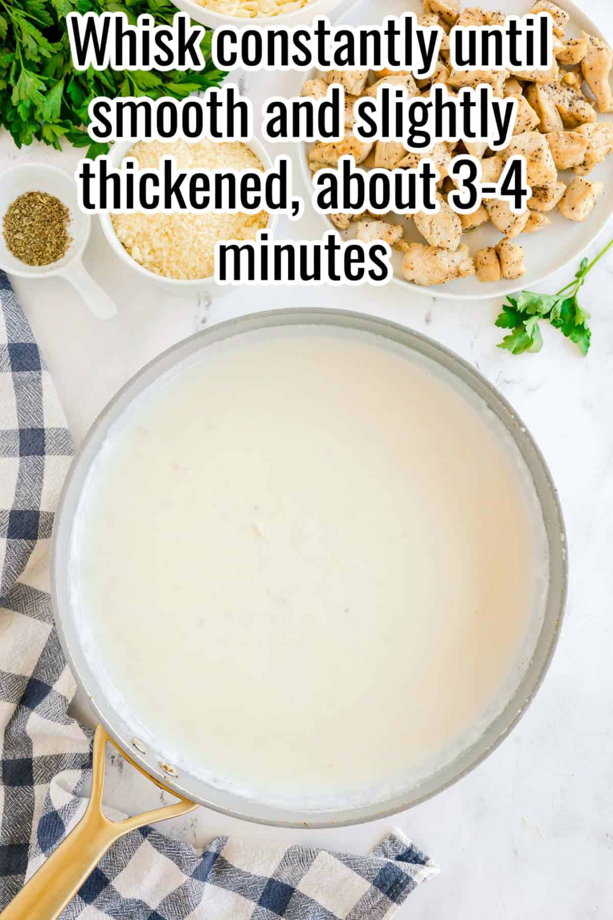 A skillet of thickened white sauce. Text on the image says 'Whisk constantly until smooth and slightly thickened, about 3–4 minutes'.