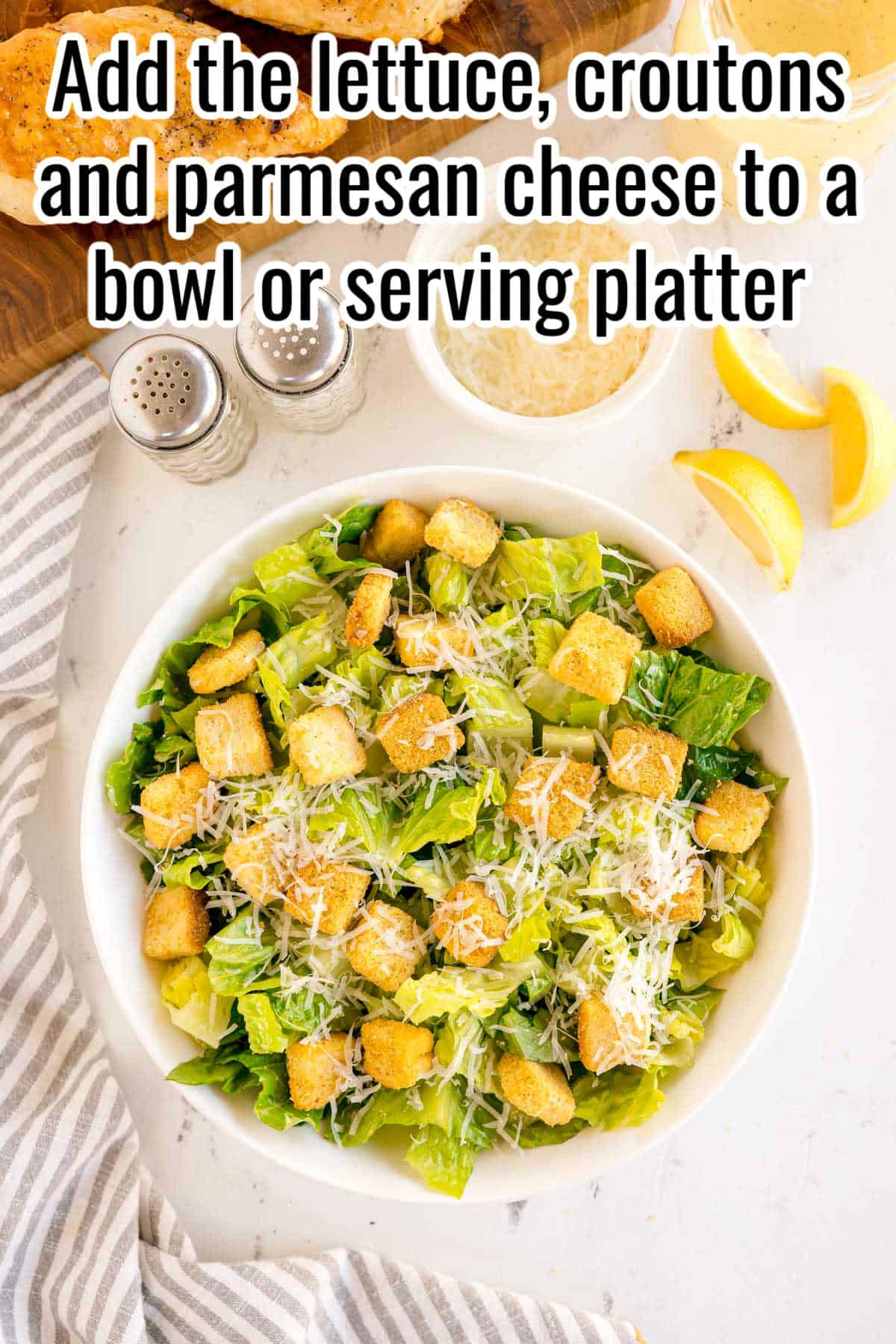 A bowl of romaine, croutons, and shredded parmesan. Text on the image says 'Add the lettuce, croutons and parmesan cheese to a bowl or serving platter'.