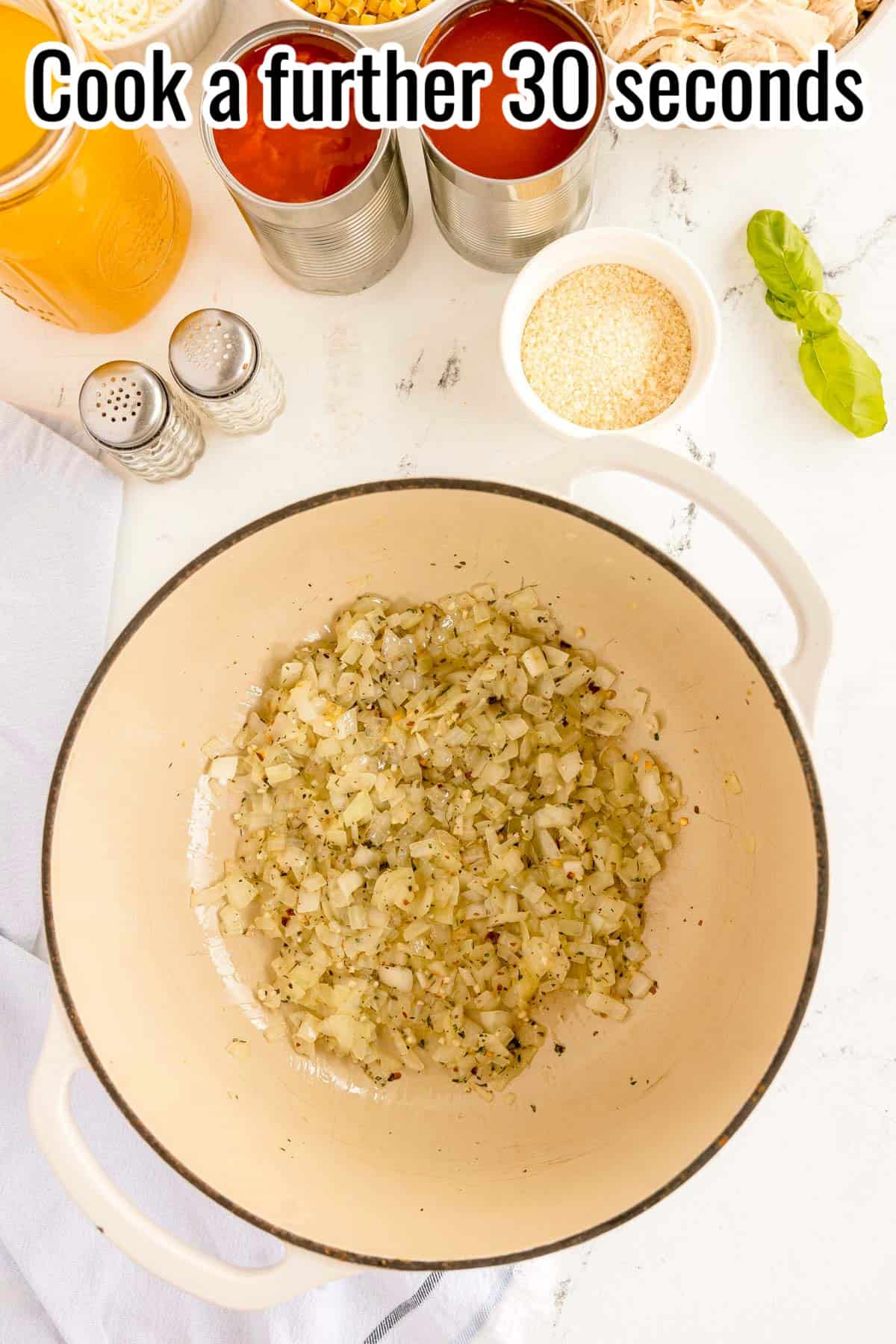 Seasoned onions cooking in a pot. Text on the image says 'Cook a further 30 seconds'.