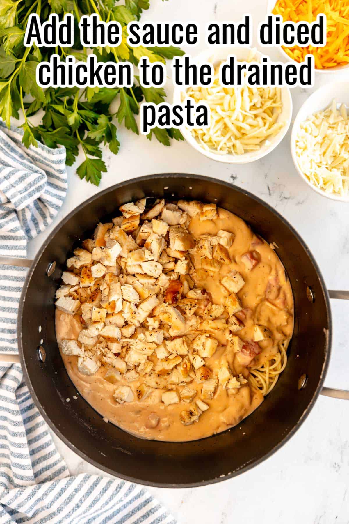 Add the creamy sauce and diced chicken to the spaghetti.