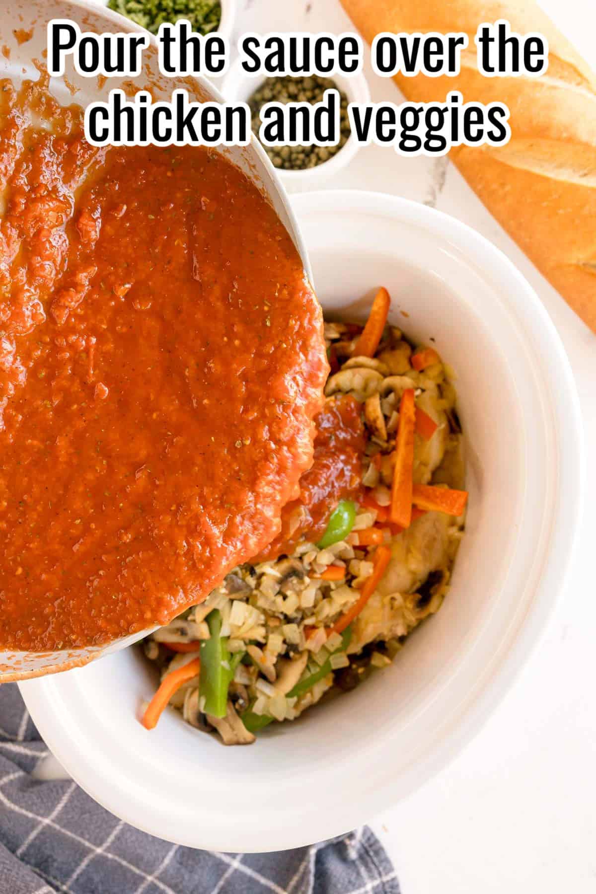 Tomato sauce being poured from a skillet over chicken and vegetables in a crockpot, with a text overlay that reads "Pour the sauce over the chicken and veggies."