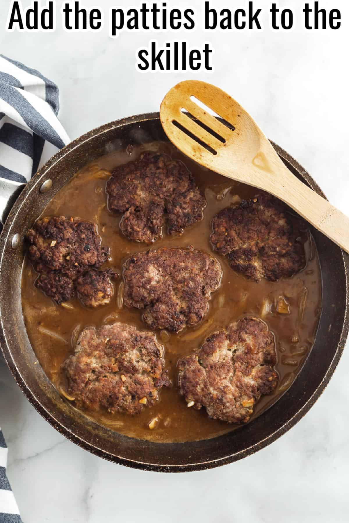 Browned hamburger patties added back into a skillet with onion gravy, with text overlay reading "Add the patties back to the skillet."