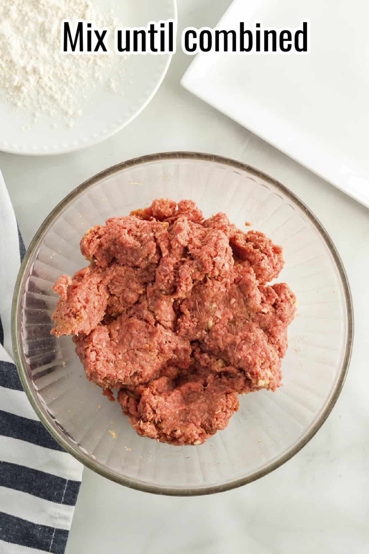 A bowl of mixed ground beef, breadcrumbs, and seasonings, ready for shaping, with text overlay reading "Mix until combined."