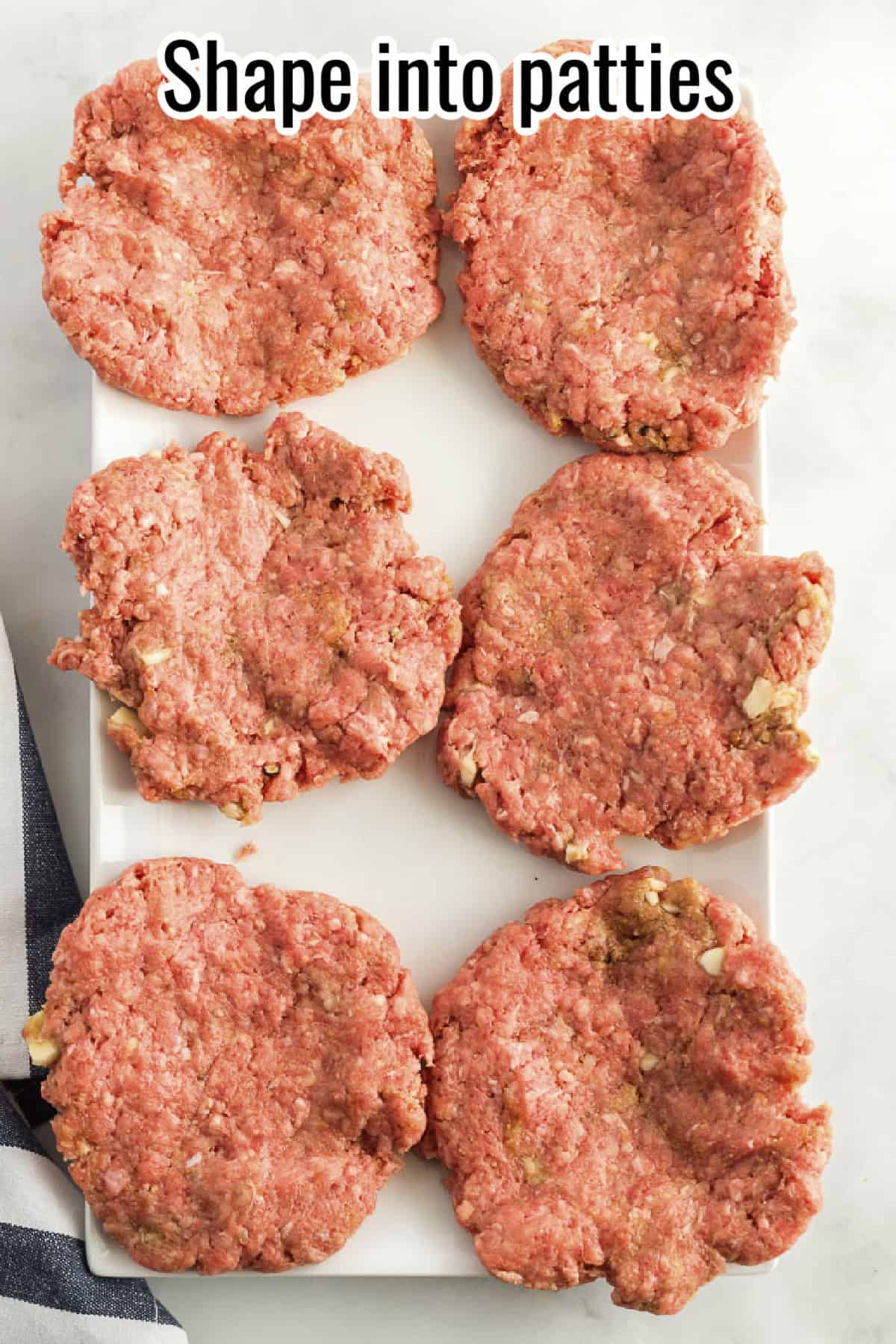 Flattened beef patties arranged on a white plate, shaped into round disks, with text overlay reading "Shape into patties."