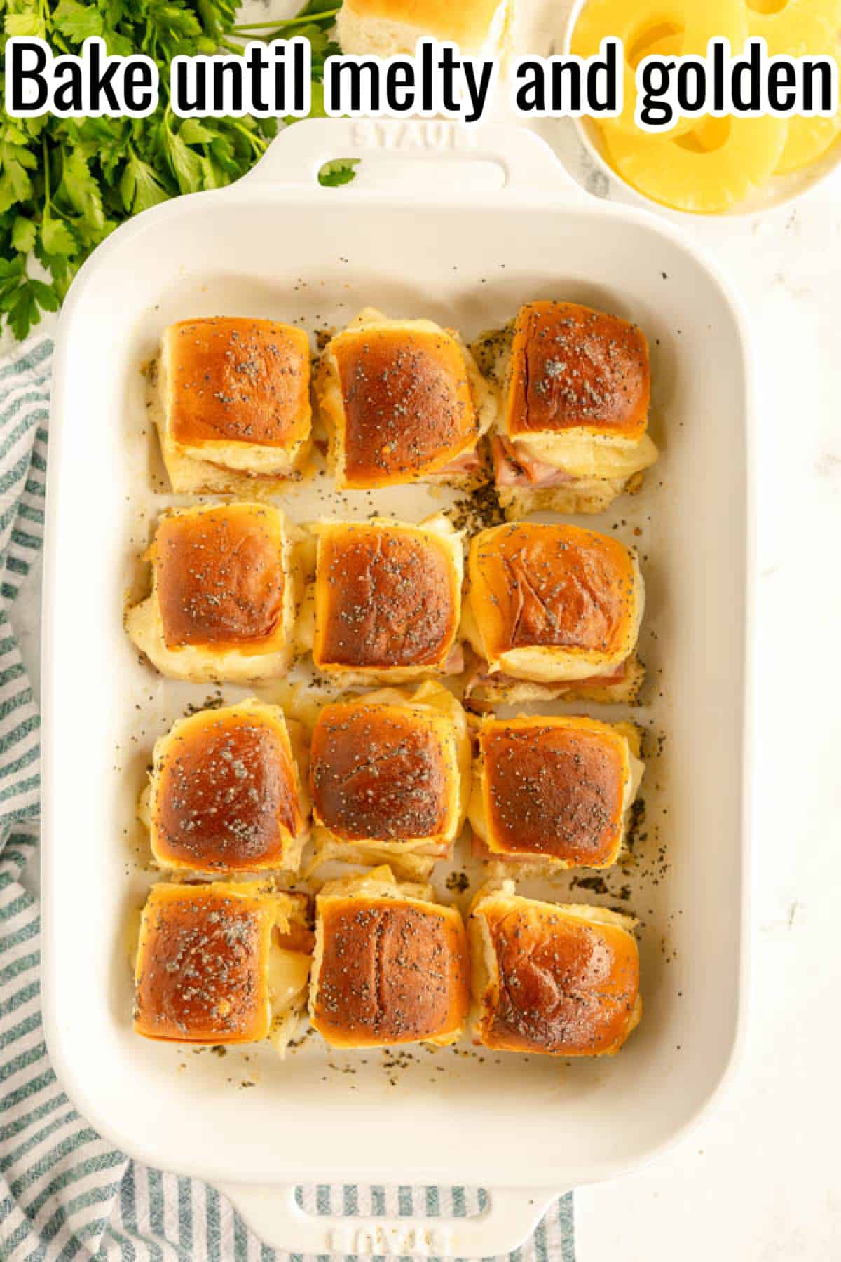 Bake the ham and cheese sliders until melted and golden.