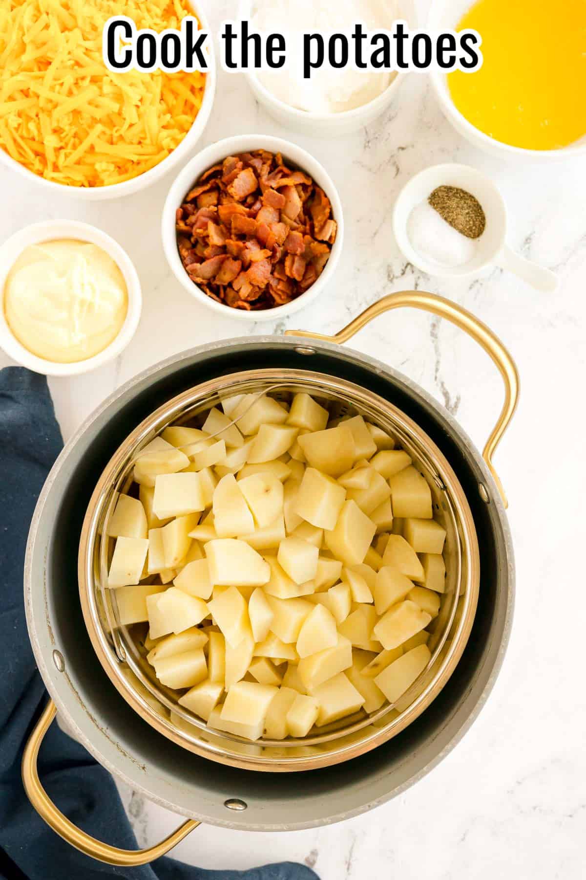 Diced potatoes in a steamer basket inside a pot, with other ingredients nearby. Text on the image says 'Cook the potatoes'.