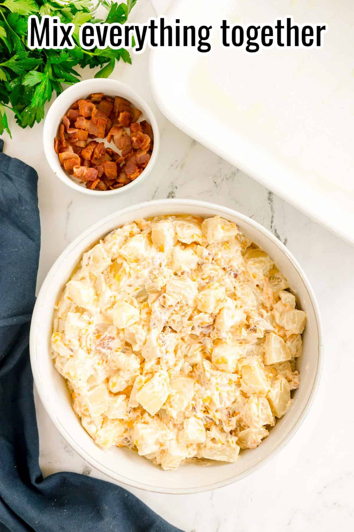The ingredients mixed together in a creamy potato mixture in a white bowl. Text on the image says 'Mix everything together'.