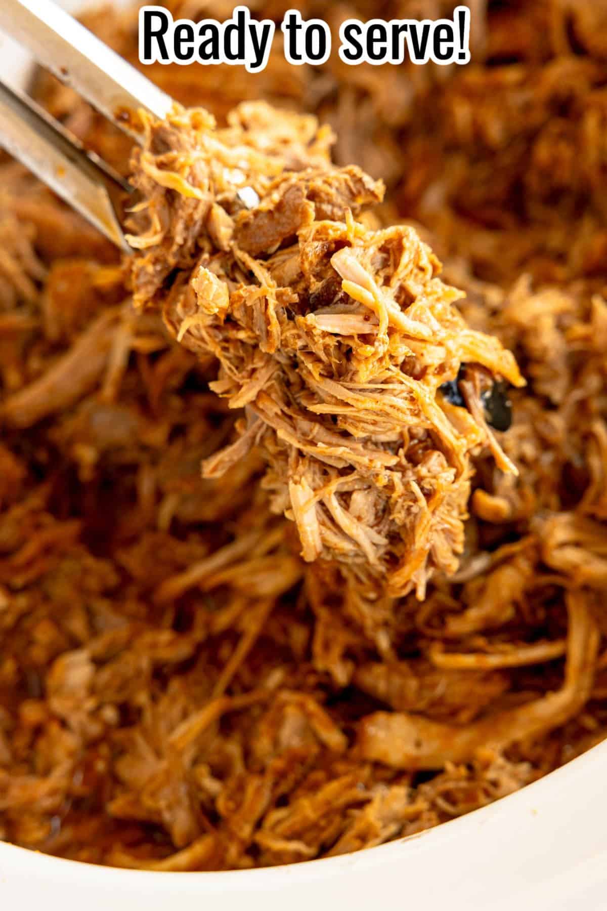 Close-up of shredded, seasoned meat being lifted by tongs from a bowl, with text above stating "Ready to serve!".