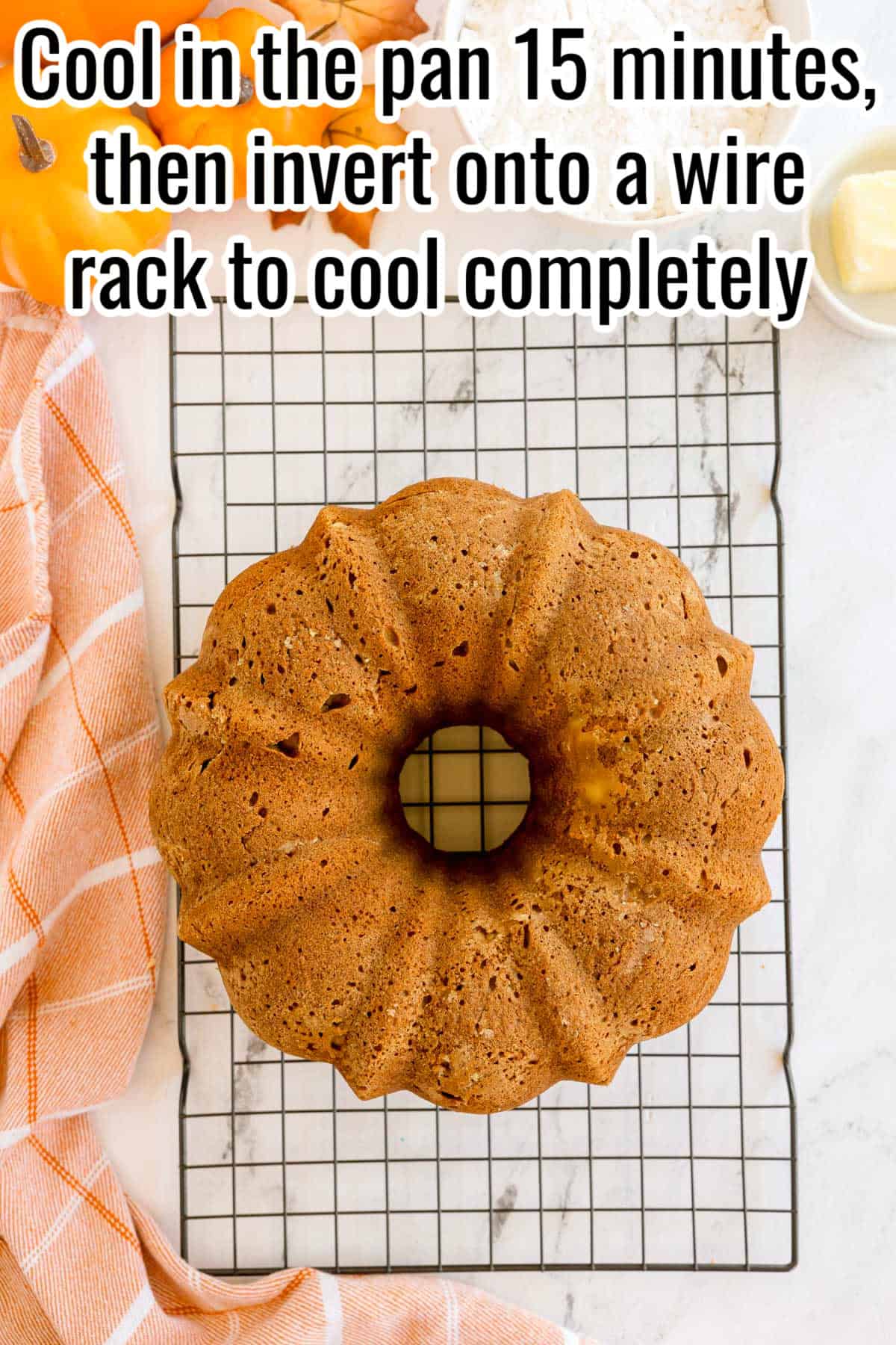A pumpkin Bundt cake cooling on a wire rack. Text on the image says 'Cool in the pan 15 minutes, then invert onto a wire rack to cool completely'.