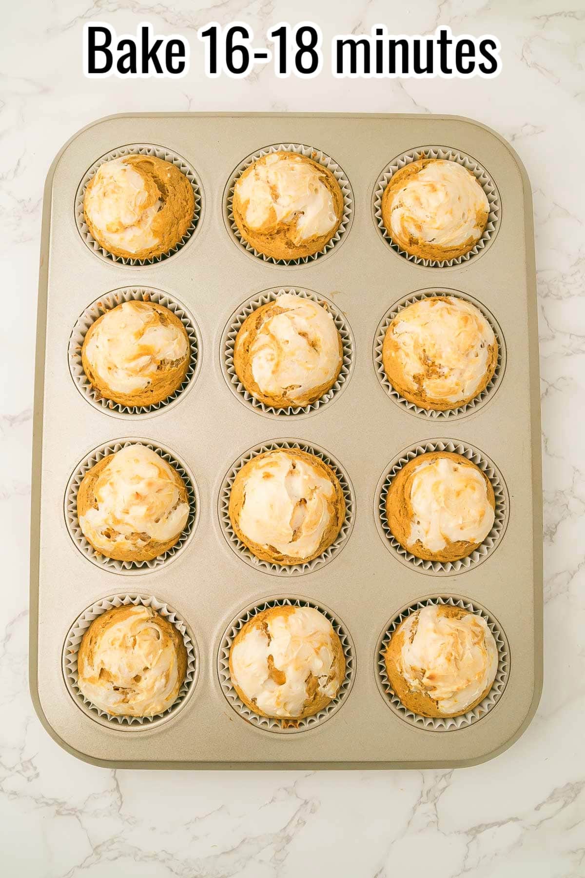 Muffin tin with baked pumpkin cream cheese muffins. Text on the image says 'Bake 16-18 minutes'.