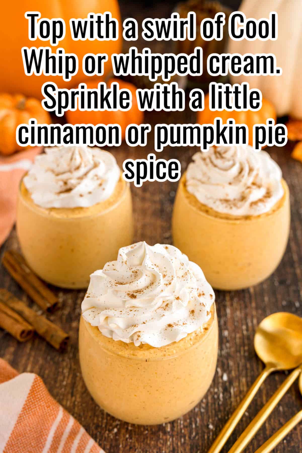 Glasses of pumpkin mousse topped with whipped cream swirls and sprinkled with cinnamon. Text on the image says 'Top with a swirl of Cool Whip or whipped cream. Sprinkle with a little cinnamon or pumpkin pie spice'.