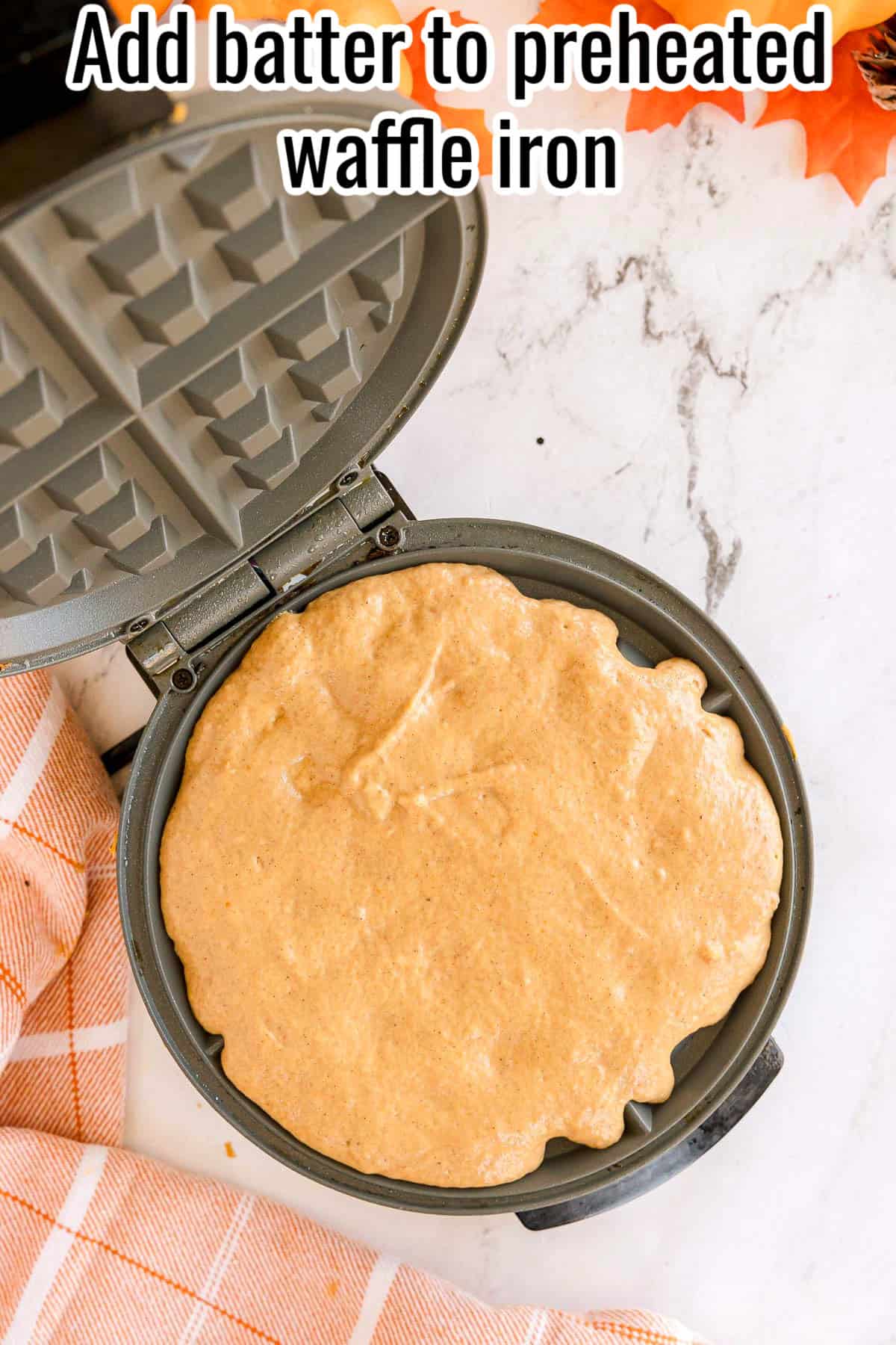 Batter spread in a preheated waffle iron. Text on the image says 'Add batter to preheated waffle iron'.