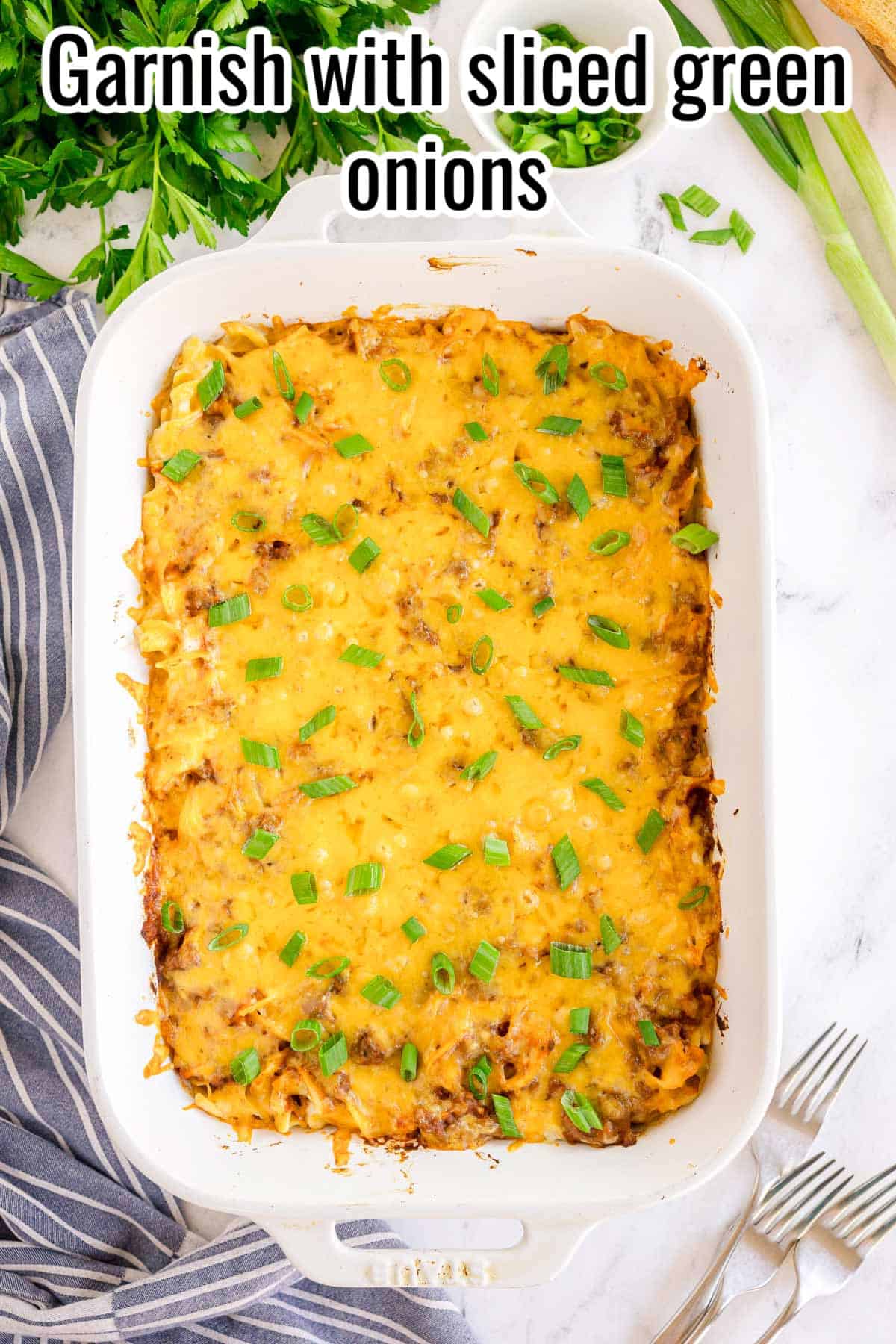 Baked noodle casserole topped with sliced green onions. Text on the image says 'Garnish with sliced green onions'