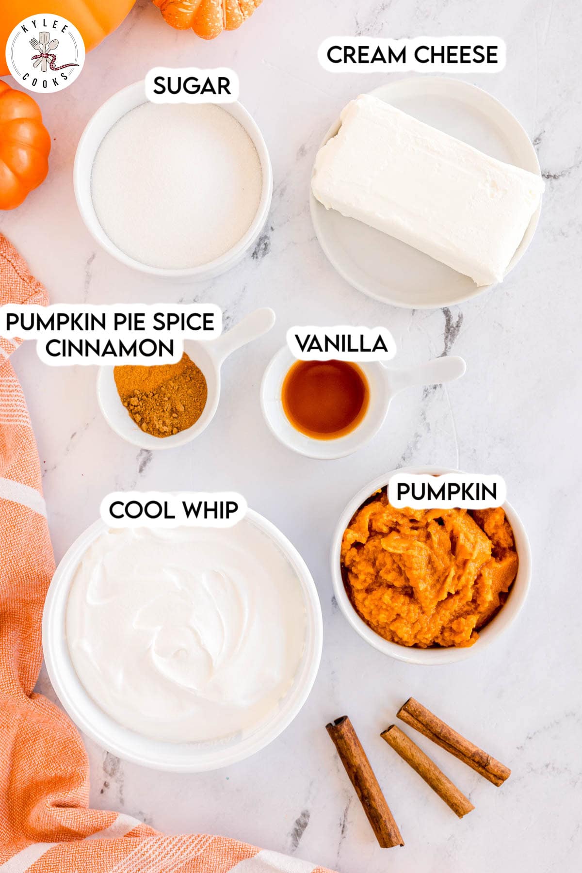 Bowls of sugar, cream cheese, pumpkin pie spice, cinnamon, vanilla, whipped topping, and pumpkin puree labeled with text.