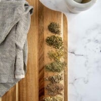 tuscan seasoning ingredients laid out on a chopping board